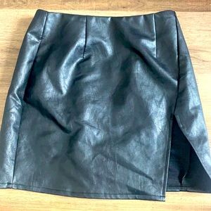 Black leather mini skirt with leg slit